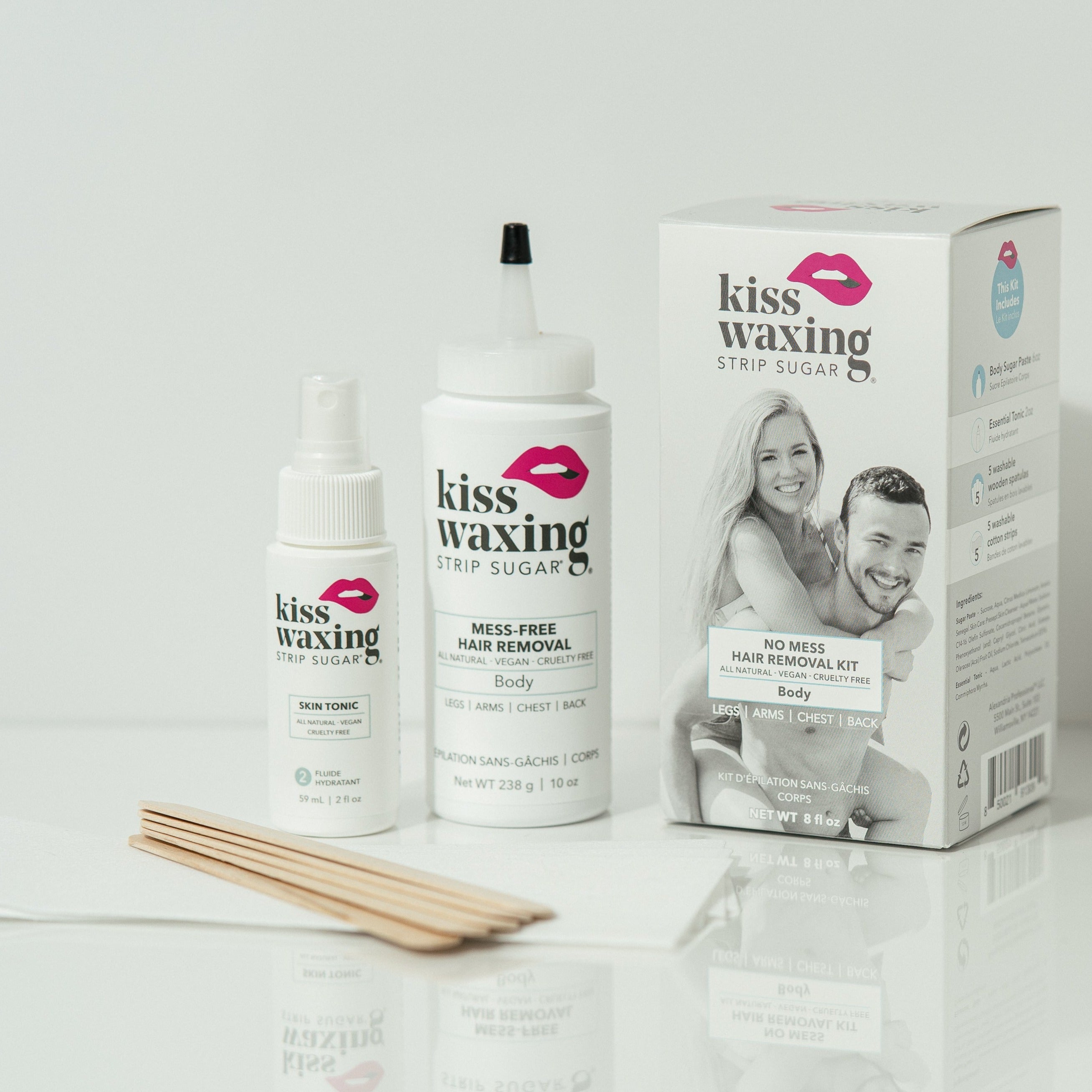 Kiss Waxing no-mess hair removal kit featuring the included products outside the box on a white background